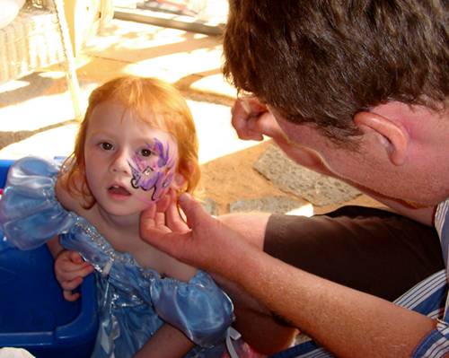 Very patient little girl face painting